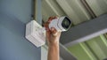 Technician installing wireless CCTV camera by screwed for home security system and installed w Royalty Free Stock Photo