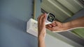 Technician installing wireless CCTV camera by screwed for home security system and installed w Royalty Free Stock Photo