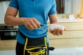 A technician installs a security alarm siren in a modern apartment.