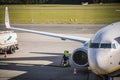 Technician looking at the engine of Ryanair plane