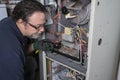 Technician Looking Over A Gas Furnace Royalty Free Stock Photo