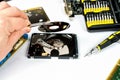 Technician makes a hard drive dissection, computer repair Royalty Free Stock Photo