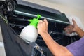 Technician man cleaning air conditioner indoors, Repairman fixing modern air conditioner, Maintenance and repairing concepts Royalty Free Stock Photo