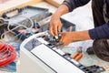 Technician man installing an air conditioning in a client house, Electrician mounting the wires into air conditioning unit, Royalty Free Stock Photo