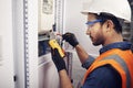 Technician, man and multimeter testing power for electricity, energy inspection and electrical system. Electrician Royalty Free Stock Photo