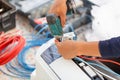 Technician man worker installing air conditioning in client house, Electrician mounting the wires into air conditioning unit, Royalty Free Stock Photo