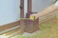 A technician measures the length with a yellow tape measure Automatic door motor gearbox Metal rails, rooted door,Electric door