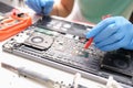 Technician measures the voltage on motherboard of computer electronic digital multimeter