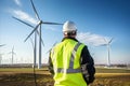 Technician monitoring vibrations in a wind turbine, Wind farm with turbines and monitoring equipment