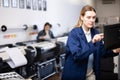 Technician operator calibrating plotter machine, typing on computer keyboard Royalty Free Stock Photo