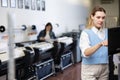 Technician operator calibrating plotter machine, typing on computer keyboard Royalty Free Stock Photo