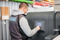 Technician operator checking status on touchscreen front display monitor station Royalty Free Stock Photo
