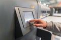 Technician operator checking status on touchscreen front display monitor station Royalty Free Stock Photo