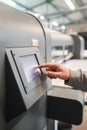 Technician operator checking status on touchscreen front display monitor station Royalty Free Stock Photo