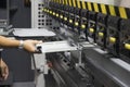 The technician operator working with hydraulic press brake bending machine. Royalty Free Stock Photo