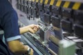 The technician operator working with hydraulic press brake bending machine. Royalty Free Stock Photo