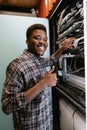 Technician organizes network equipment while smiling in data center during afternoon hours Royalty Free Stock Photo