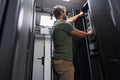 IT technician performing maintenance on servers in a modern data center server room Royalty Free Stock Photo