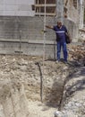 Technician places a stadia for reading through a theodolite