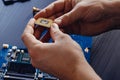 Technician plug in CPU microprocessor to computer motherboard