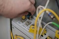 technician plugging ethernet cable into network switch for high speed internet connection and IT infrastructure maintenance Royalty Free Stock Photo