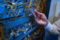 Technician plugging in optical fiber into server rack switch