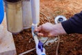 Technician plumber uses clear primer for PVC pipe before a gluing it