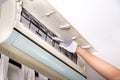 Technician pointing to air conditioner filter full of trapped du