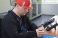 Technician prepare to make phone call in the power plant contr