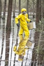 Technician in professional uniform with silver suitcase in contaminated floods area