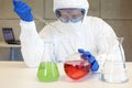 Technician in protective uniform working with chemicals