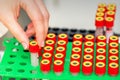 Technician puts test tube to rack Royalty Free Stock Photo