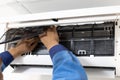 Technician putting on air filter after cleaning or replacing the new air conditioner filter,checking,cleaning service the air Royalty Free Stock Photo