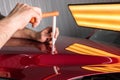 The technician removes dents on the car using the method without painting. PDR. Car body repair.