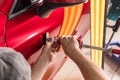 The technician removes dents on the car using the method without painting. PDR. Car body repair.