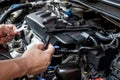 Technician Removing the gasoline injector part in engine room check dust and test pressure