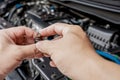 Technician Removing the gasoline injector part in engine room check hole on part dust and test pressure