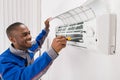 Technician Repairing Air Conditioner