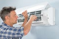 Technician repairing air conditioner Royalty Free Stock Photo