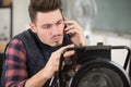 technician repairing appliance makes call on smartphone Royalty Free Stock Photo