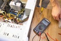 Technician repairing a broken computer in a workshop, close-up Royalty Free Stock Photo