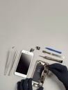 Technician repairing broken smartphone on desk Royalty Free Stock Photo