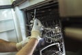 Technician Repairing Dishwasher In Kitchen, close up Royalty Free Stock Photo