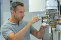 Technician repairing electric boiler Royalty Free Stock Photo