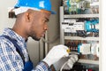 Technician Repairing Fusebox With Screwdriver Royalty Free Stock Photo