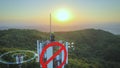 Technician repairing a 5G Telecom tower, sunset on top of a mountain Royalty Free Stock Photo