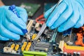 Technician repairing inside of mobile phone by soldering iron. Integrated Circuit. the concept of data, hardware, technology