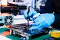 The technician repairing the motherboard in the lab with copy space. the concept of computer hardware, mobile phone, electronic, Royalty Free Stock Photo