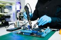 The technician repairing the motherboard in the lab with copy space. the concept of computer hardware, mobile phone, electronic, Royalty Free Stock Photo