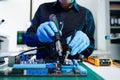 The technician repairing the motherboard in the lab with copy space. the concept of computer hardware, mobile phone, electronic, Royalty Free Stock Photo